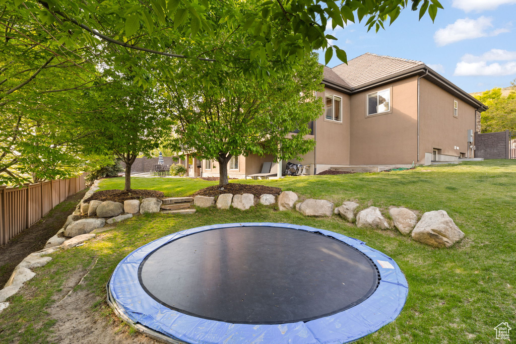 View of yard featuring a trampoline