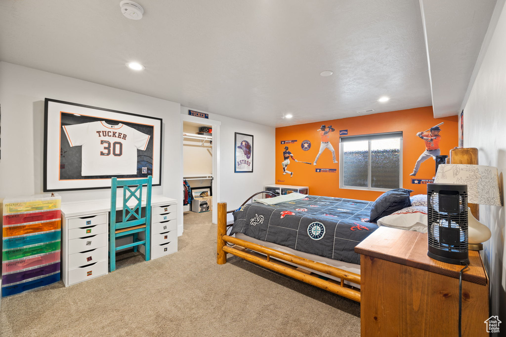 Carpeted bedroom with recessed lighting, a spacious closet, and a closet