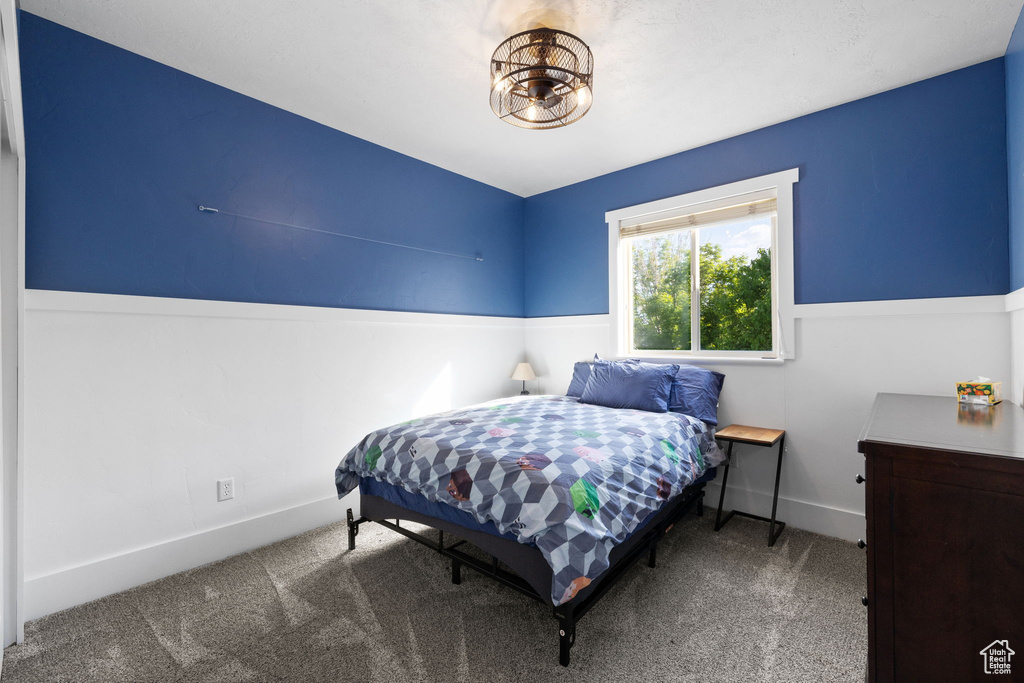Bedroom featuring carpet floors and baseboards