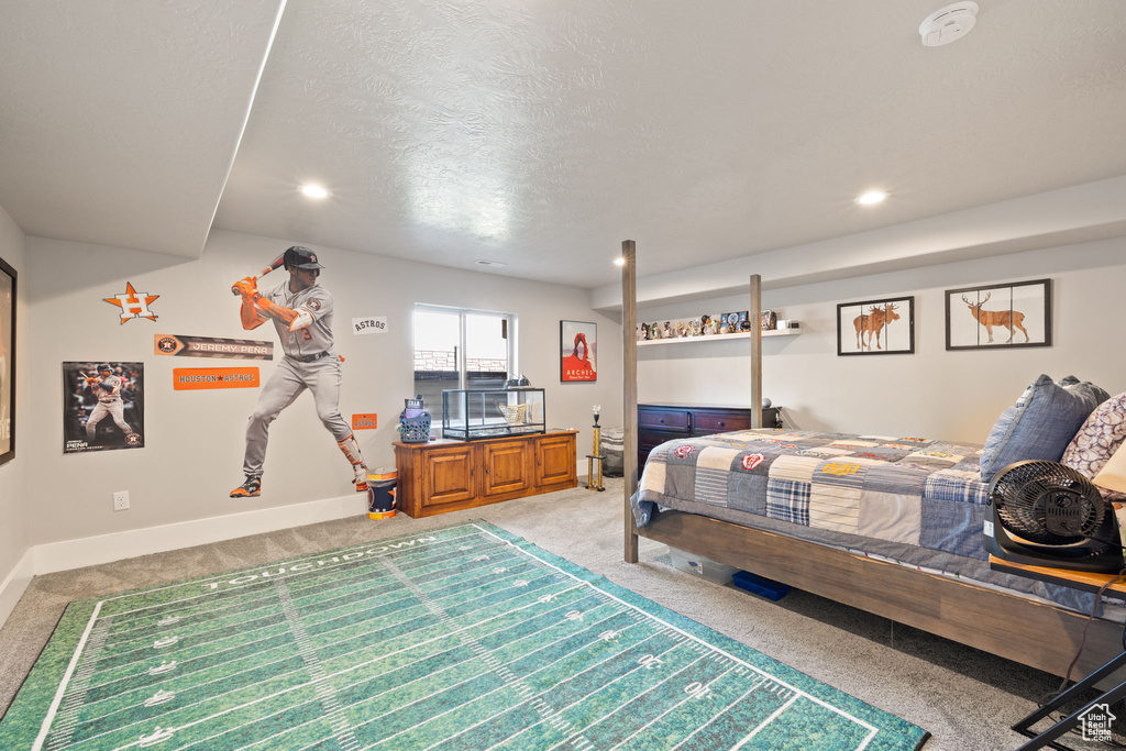 Bedroom with light colored carpet, baseboards, recessed lighting, and a textured ceiling