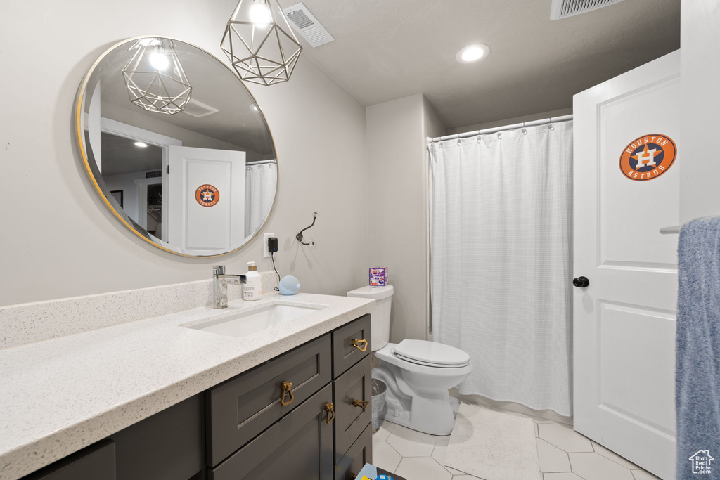 Full bathroom featuring vanity, tile patterned floors, toilet, and recessed lighting