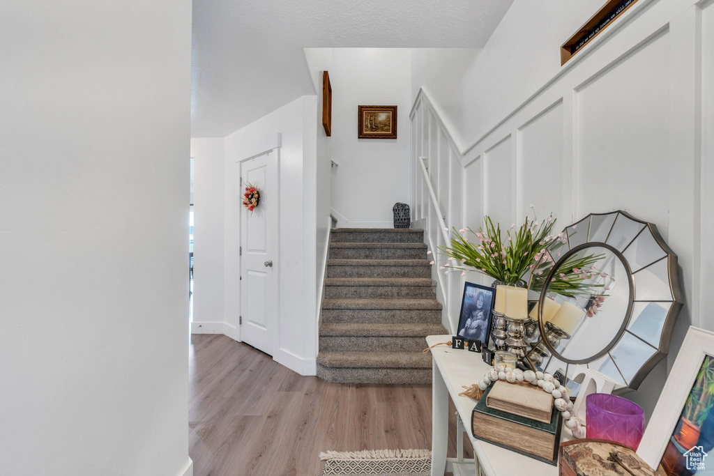 Stairway featuring wood finished floors and baseboards