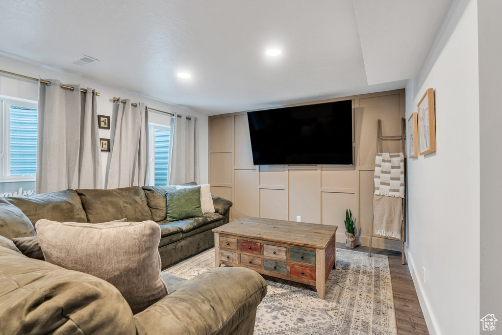 Living area featuring wood finished floors, recessed lighting, and baseboards