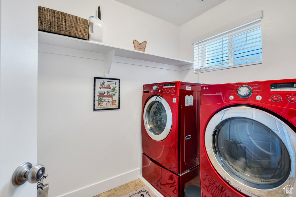 Laundry area featuring independent washer and dryer, baseboards, and tile patterned floors