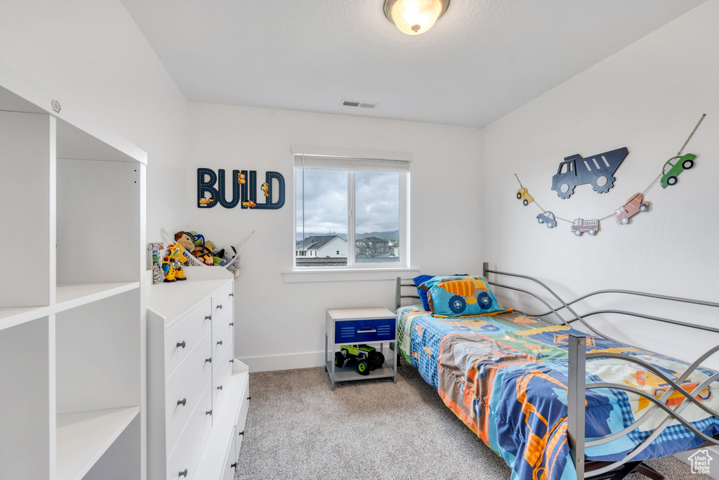 Carpeted bedroom featuring baseboards