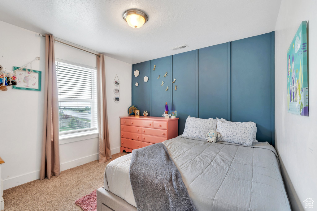 Carpeted bedroom with baseboards