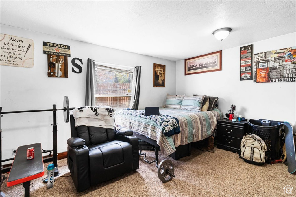 Bedroom with carpet floors and a textured ceiling