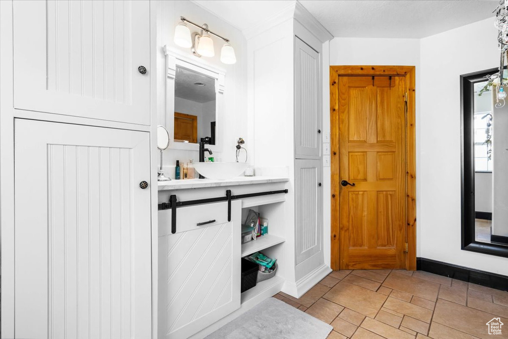 Bathroom featuring baseboards and a sink