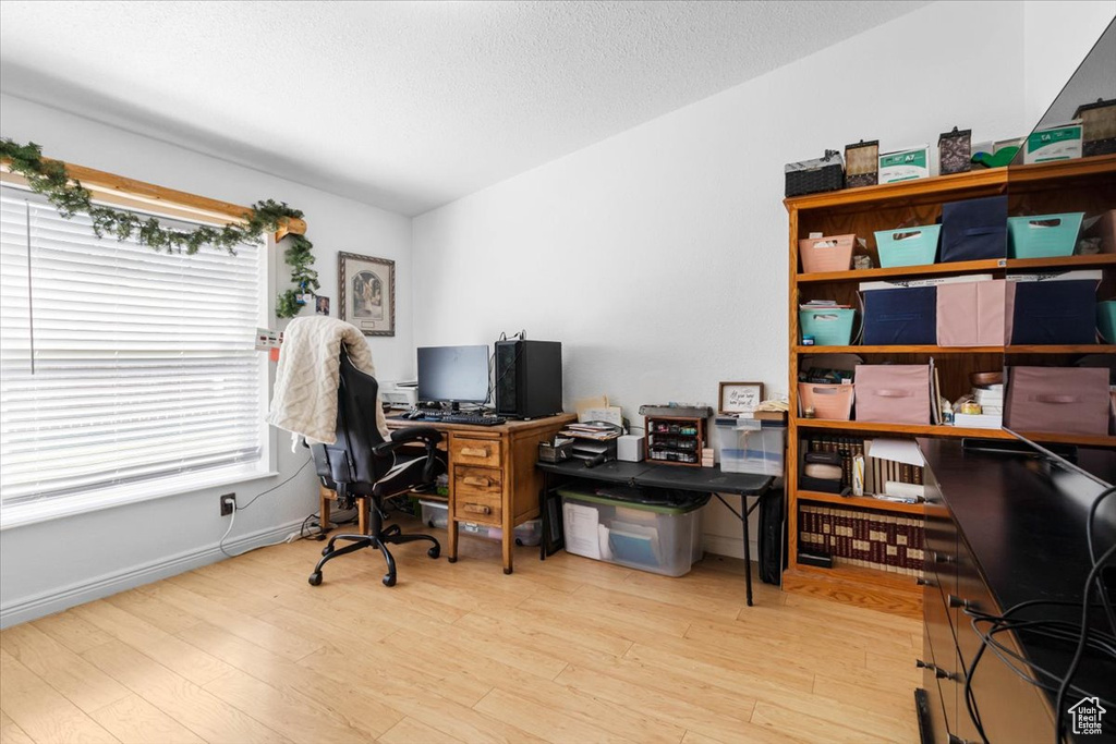 Office area with wood finished floors and a textured ceiling