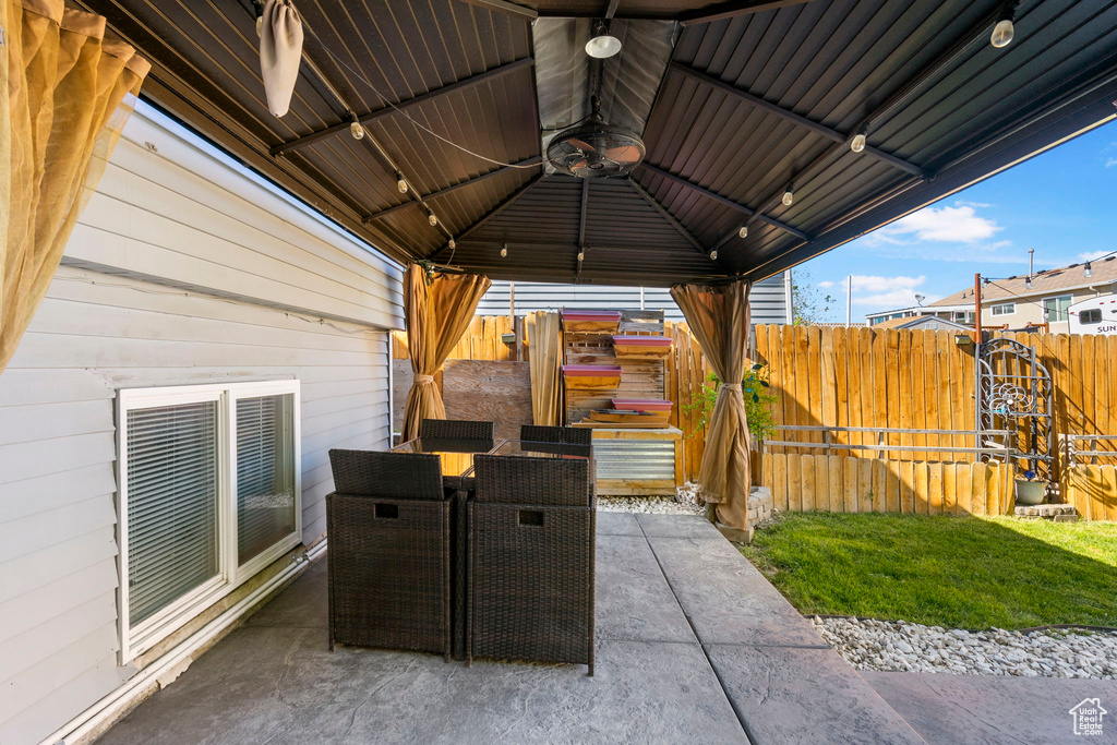 View of patio / terrace featuring fence, a gazebo, and outdoor dining area