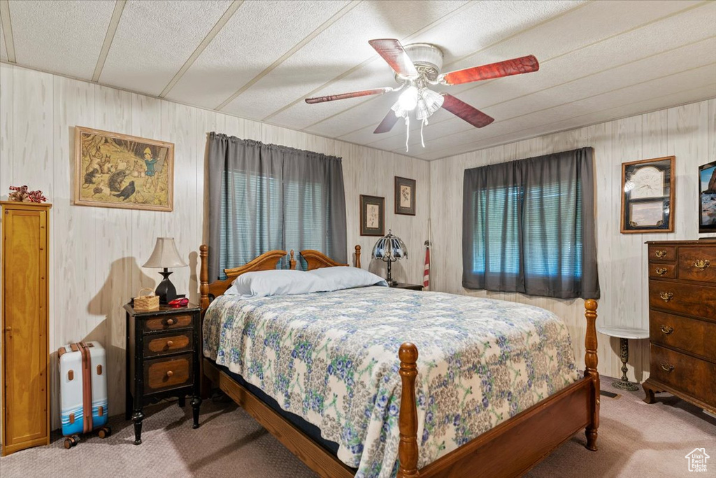 Carpeted bedroom featuring ceiling fan