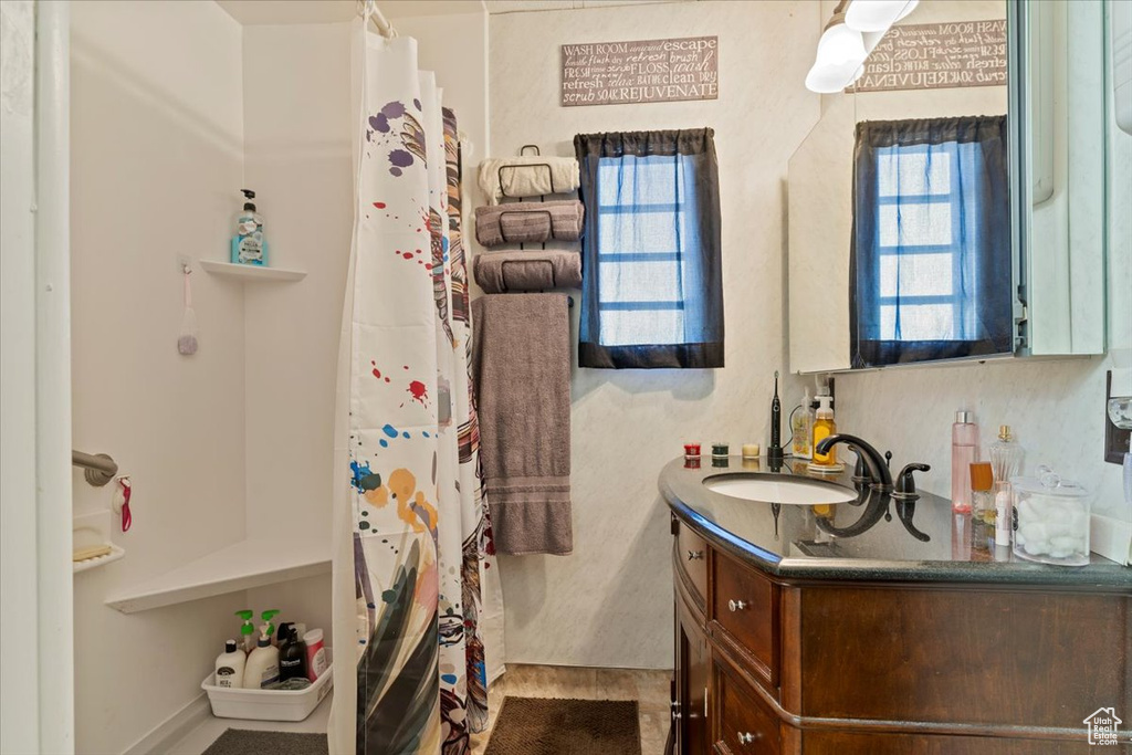 Full bathroom featuring vanity and curtained shower