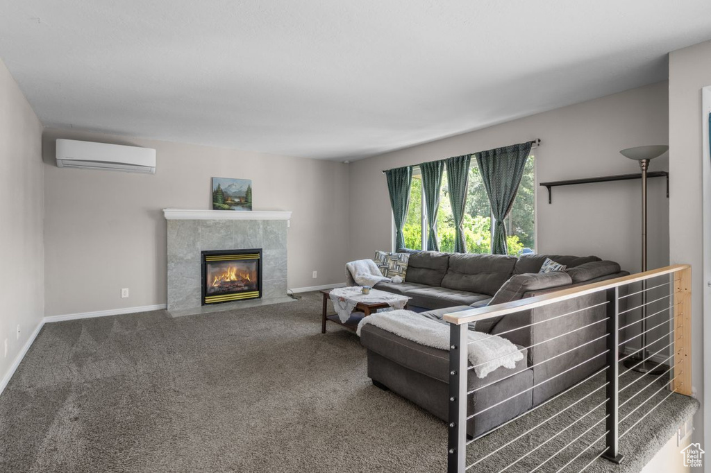 Carpeted living room featuring a wall unit AC, a premium fireplace, and baseboards
