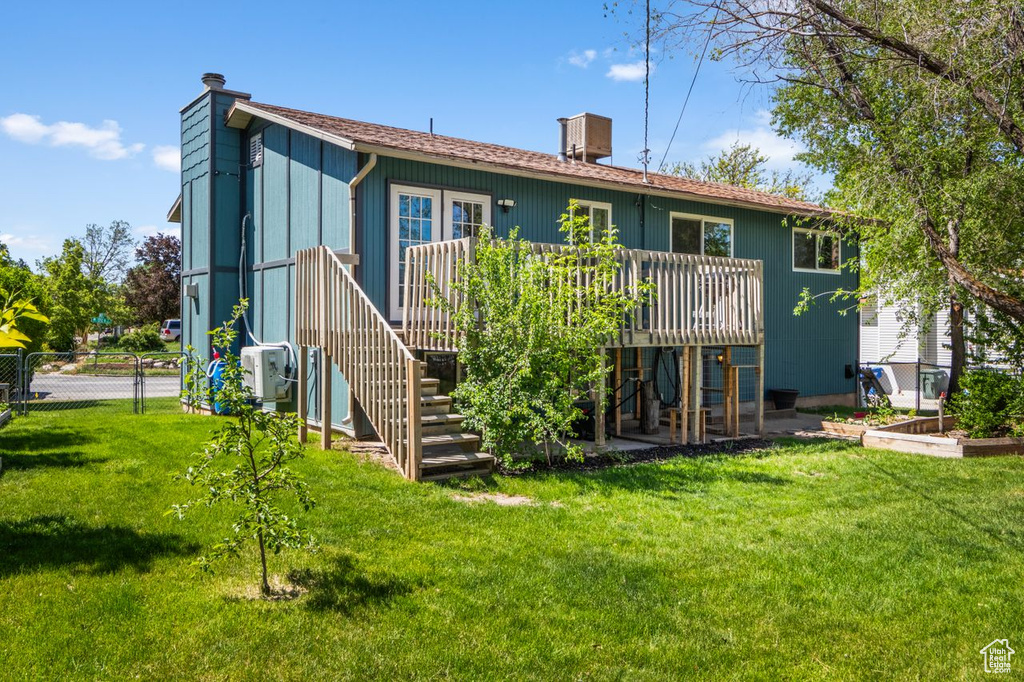 Back of property with a wooden deck and a chimney