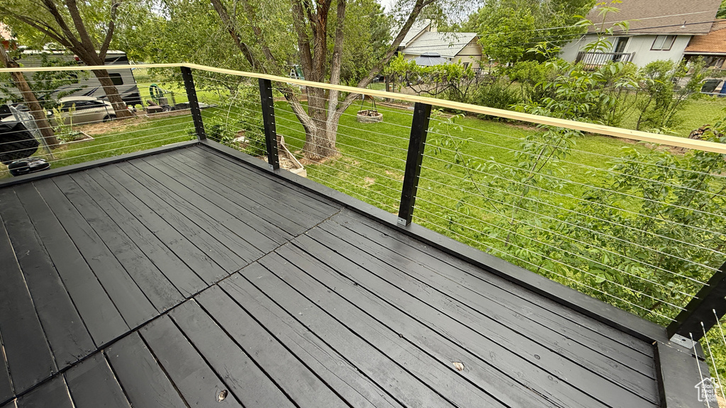 Wooden deck featuring a lawn