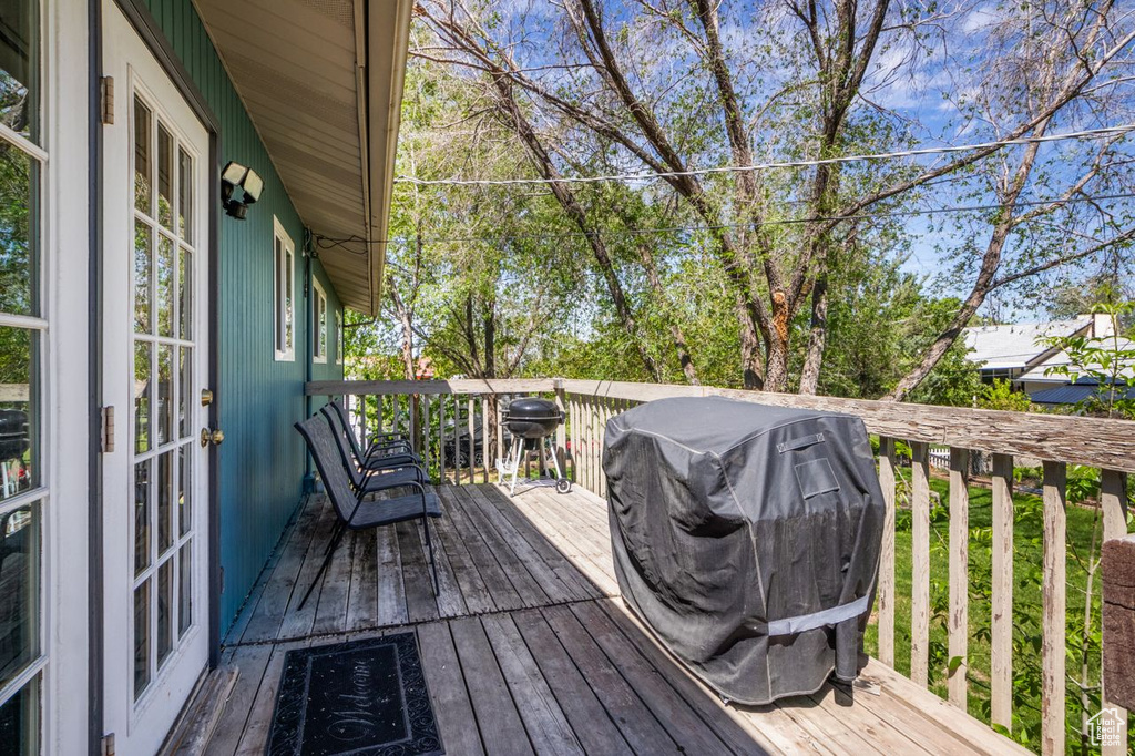 Wooden deck featuring a grill and french doors