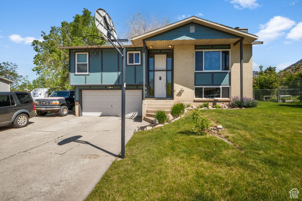View of front of house featuring brick siding, a garage, and concrete driveway