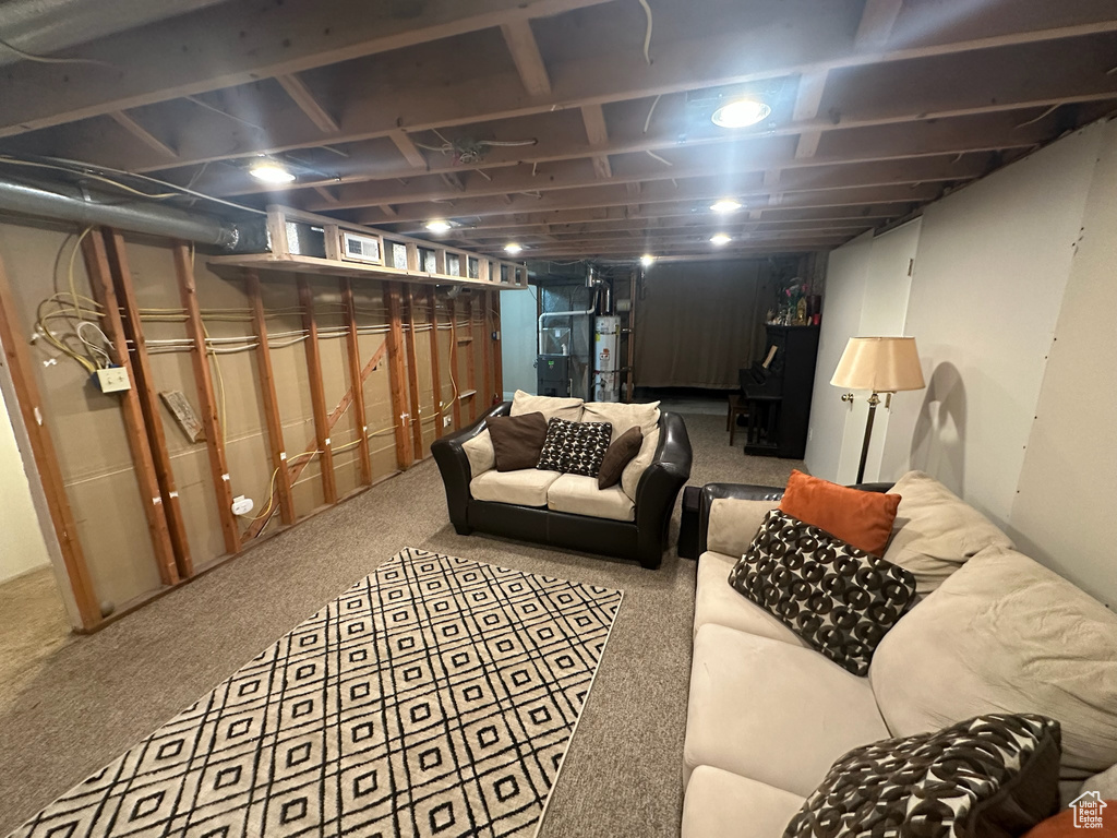 Finished below grade area featuring secured water heater and carpet floors