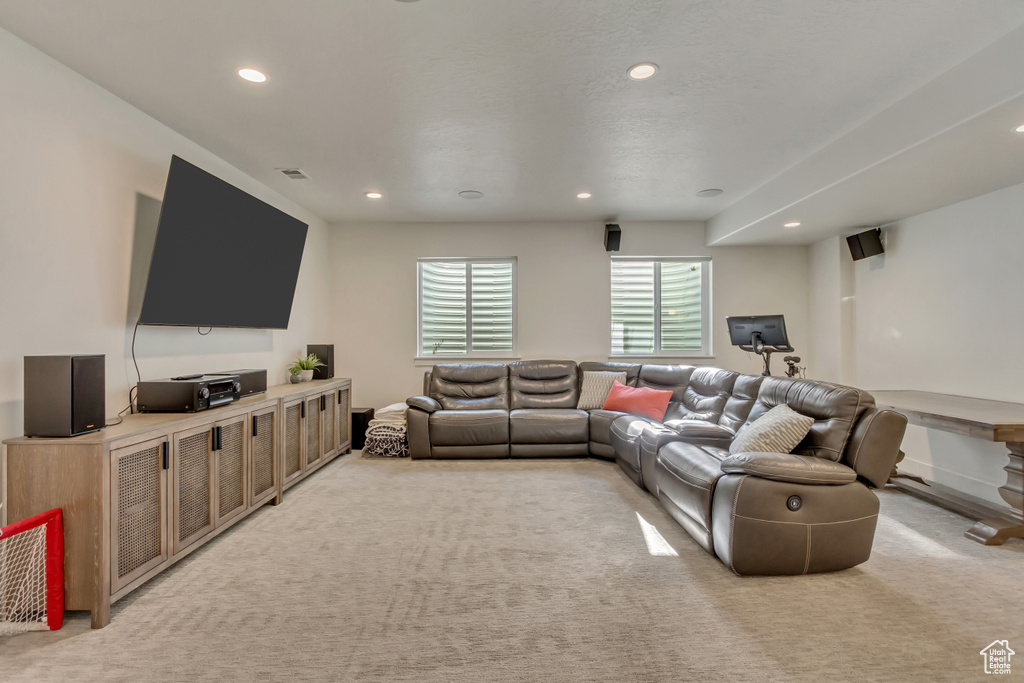 Living room with recessed lighting and light colored carpet