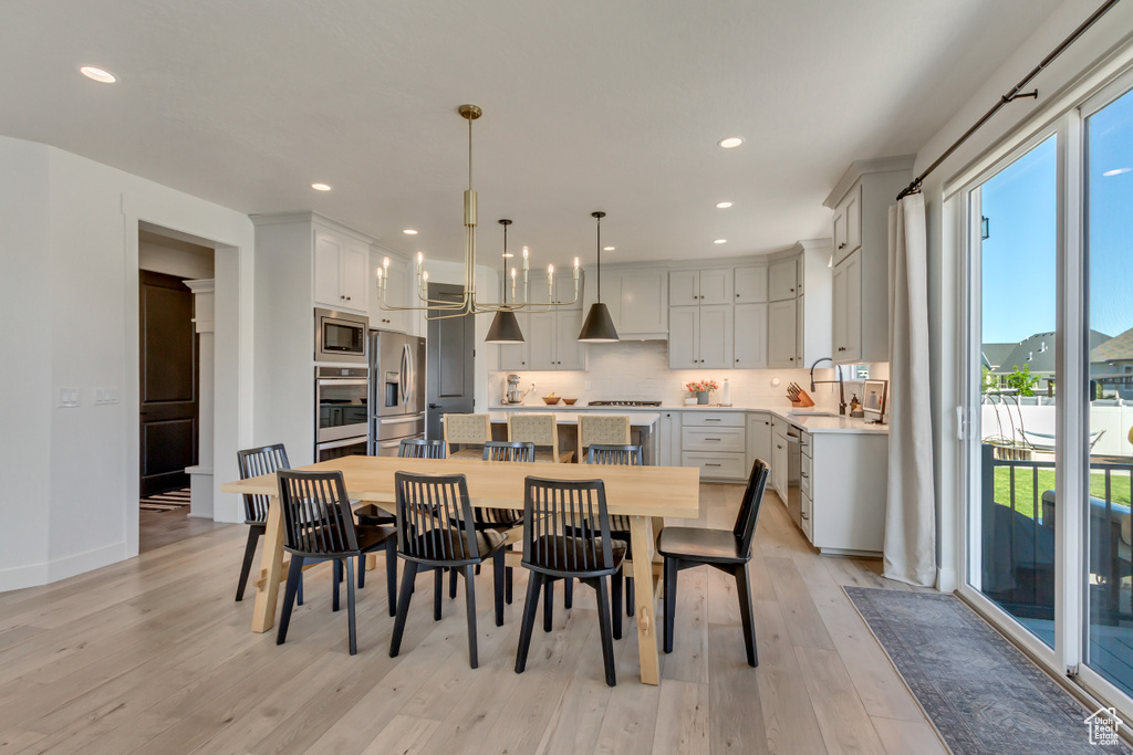 Dining room featuring light wood-style flooring, recessed lighting, and baseboards