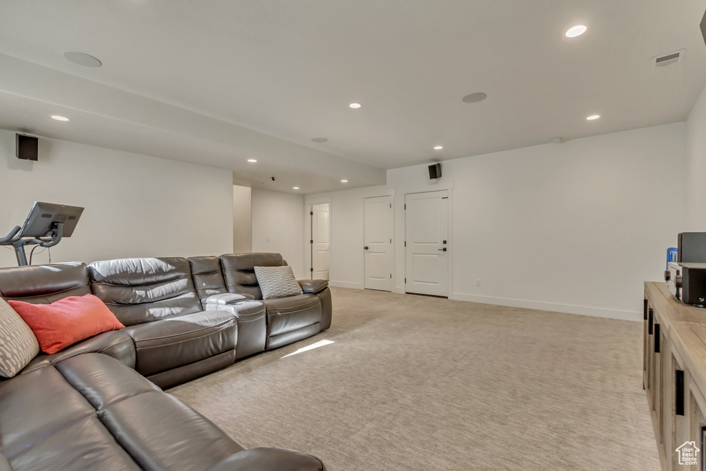 Living area featuring recessed lighting, light carpet, and baseboards