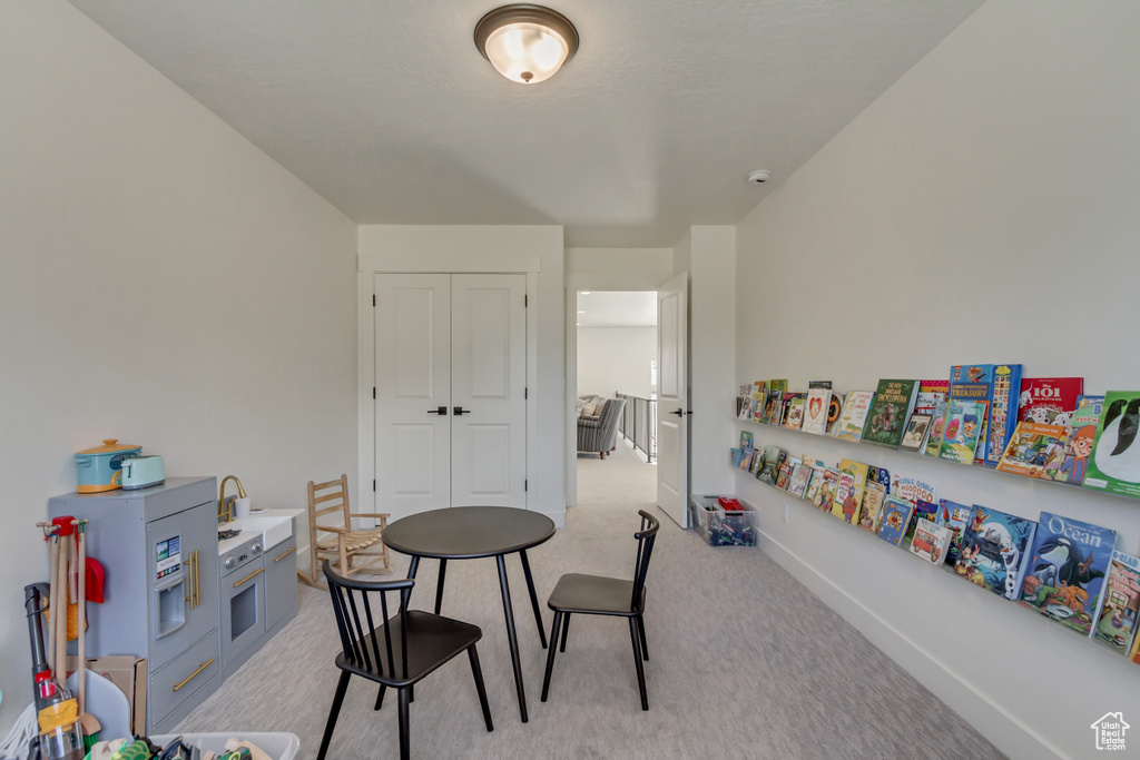 Rec room with light carpet and baseboards