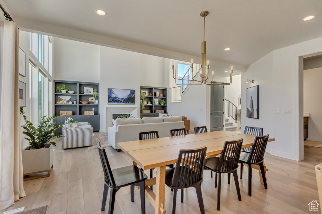 Dining space featuring stairway, light wood-style floors, a chandelier, recessed lighting, and baseboards