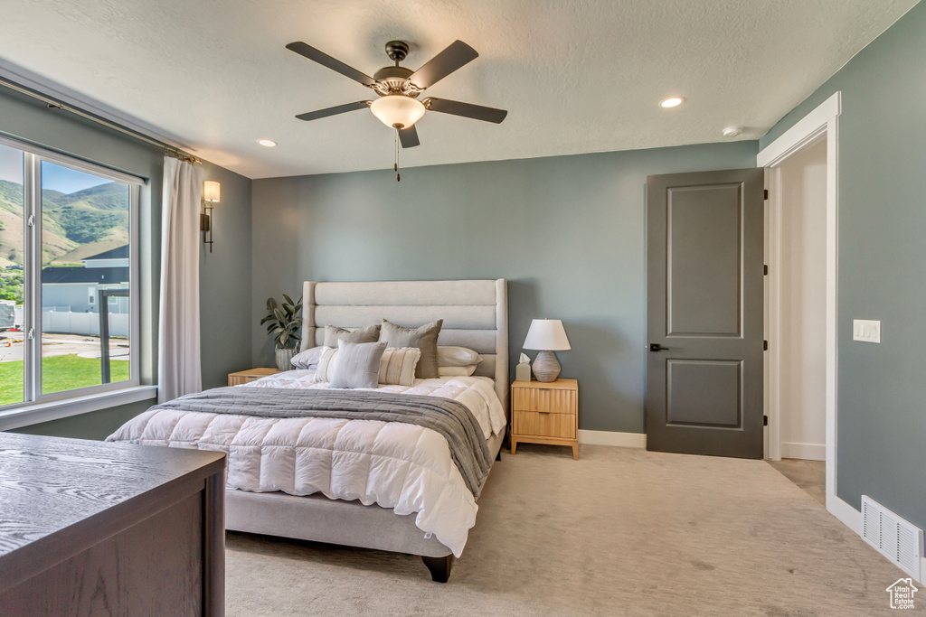 Bedroom with light colored carpet, recessed lighting, baseboards, and a ceiling fan