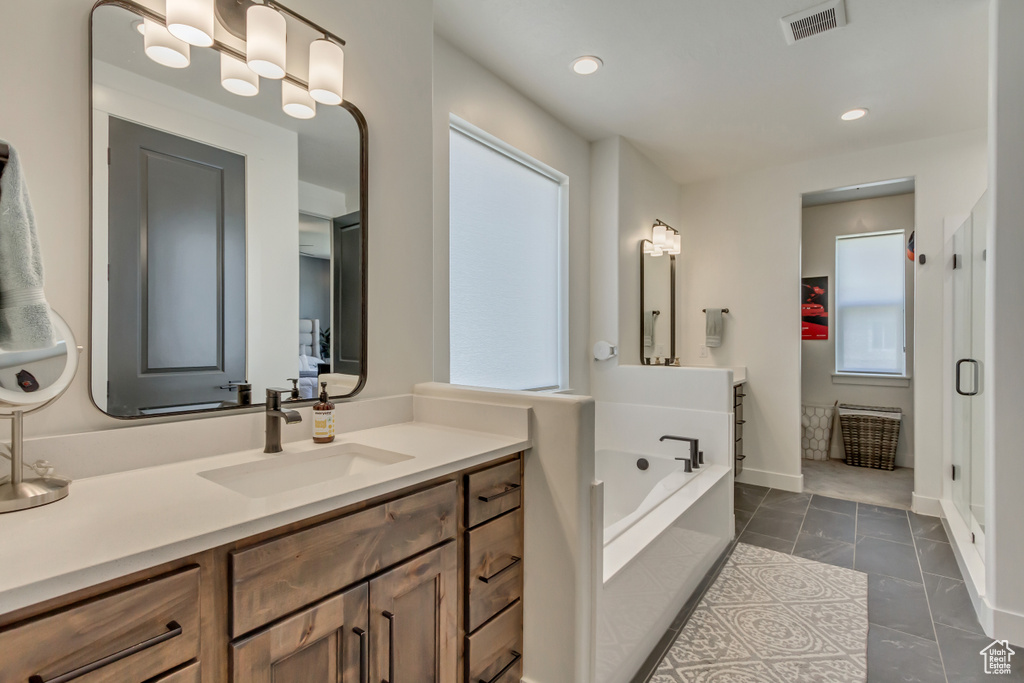 Bathroom with a bath, tile patterned floors, vanity, recessed lighting, and a stall shower