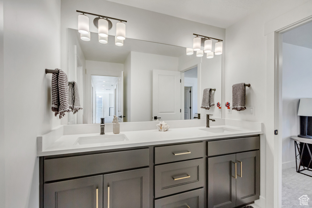 Bathroom featuring double vanity and baseboards