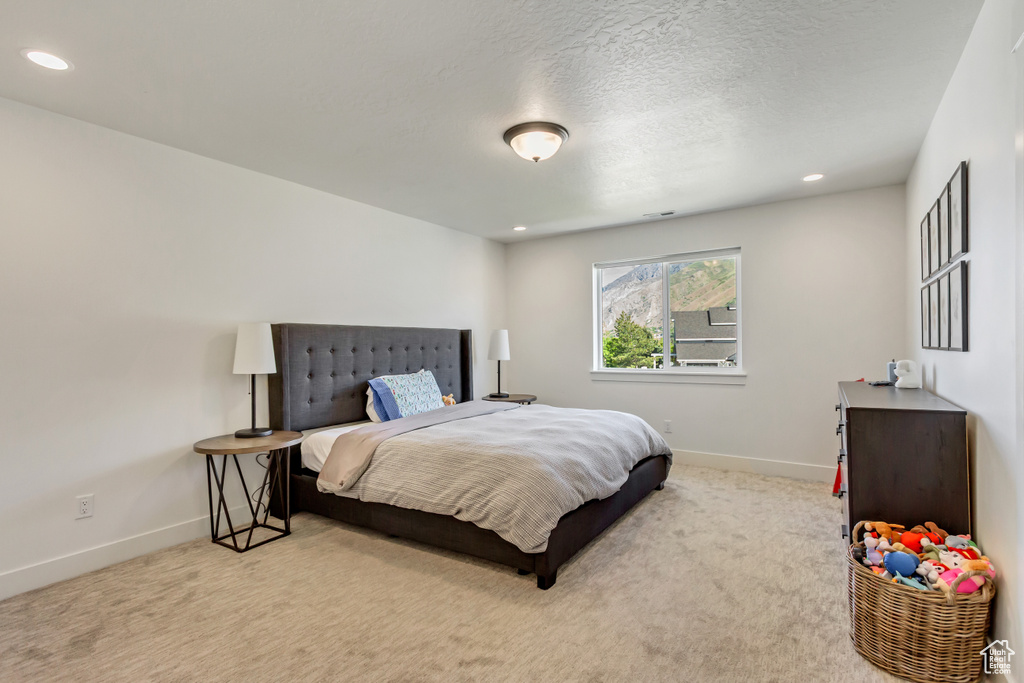 Carpeted bedroom with baseboards and recessed lighting