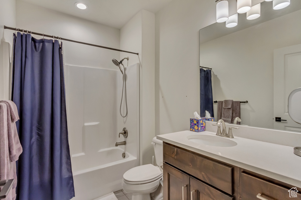 Bathroom with vanity, toilet, shower / bath combo, and tile patterned flooring