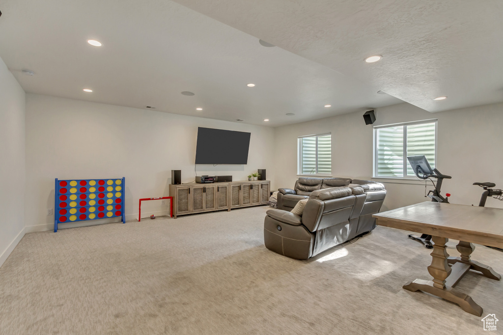 Carpeted living room featuring recessed lighting and baseboards