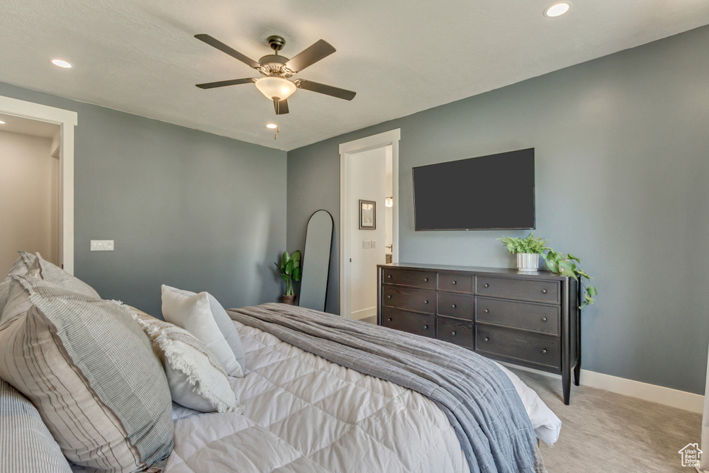 Bedroom featuring light carpet, recessed lighting, baseboards, a ceiling fan, and ensuite bathroom