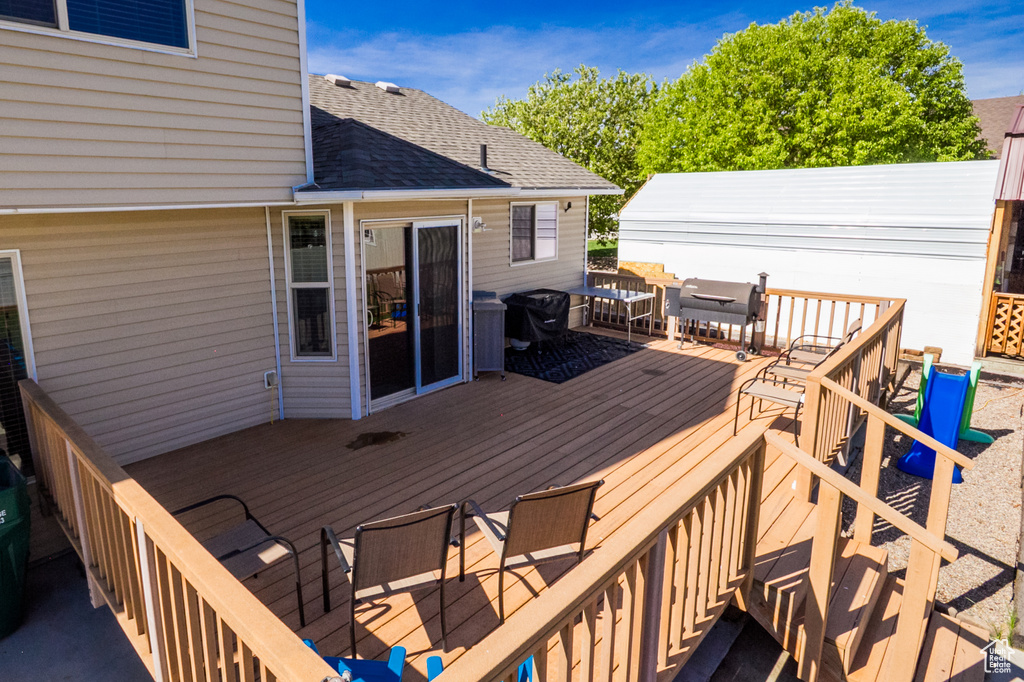Deck featuring outdoor dining area and grilling area