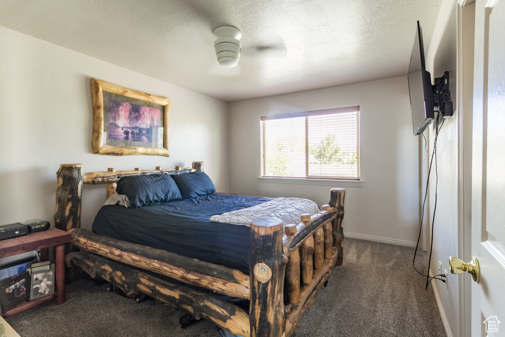 Bedroom with carpet, a ceiling fan, and baseboards