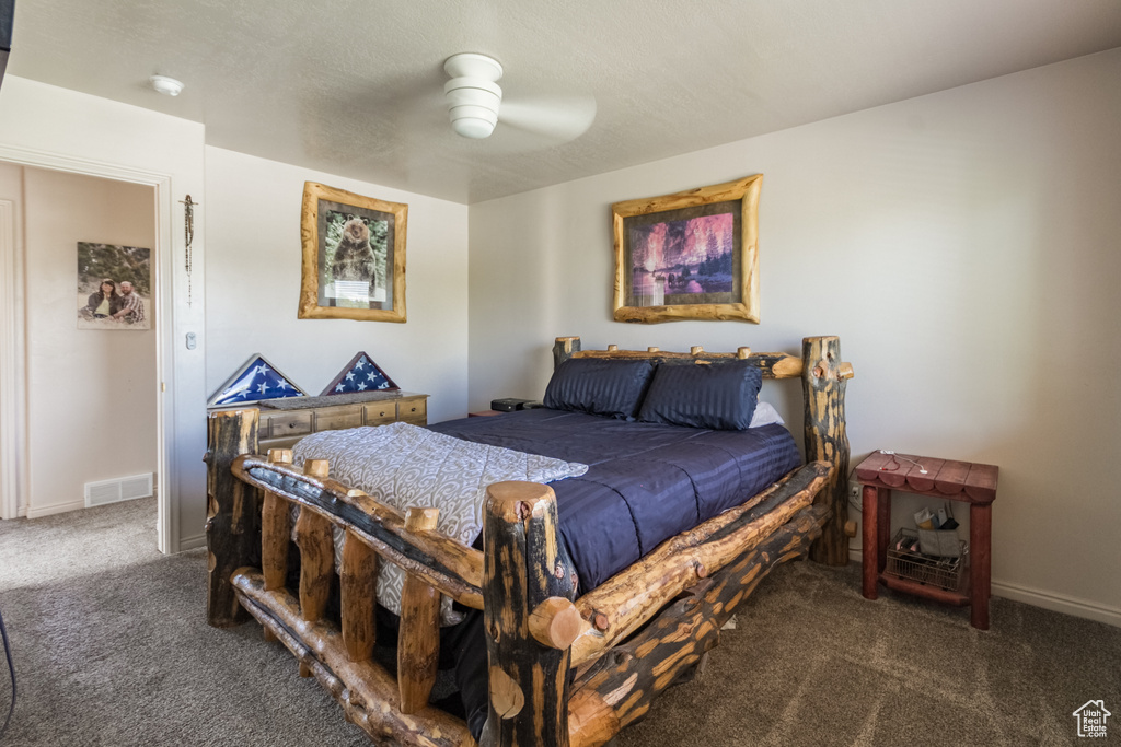 Bedroom with carpet flooring, baseboards, and a ceiling fan