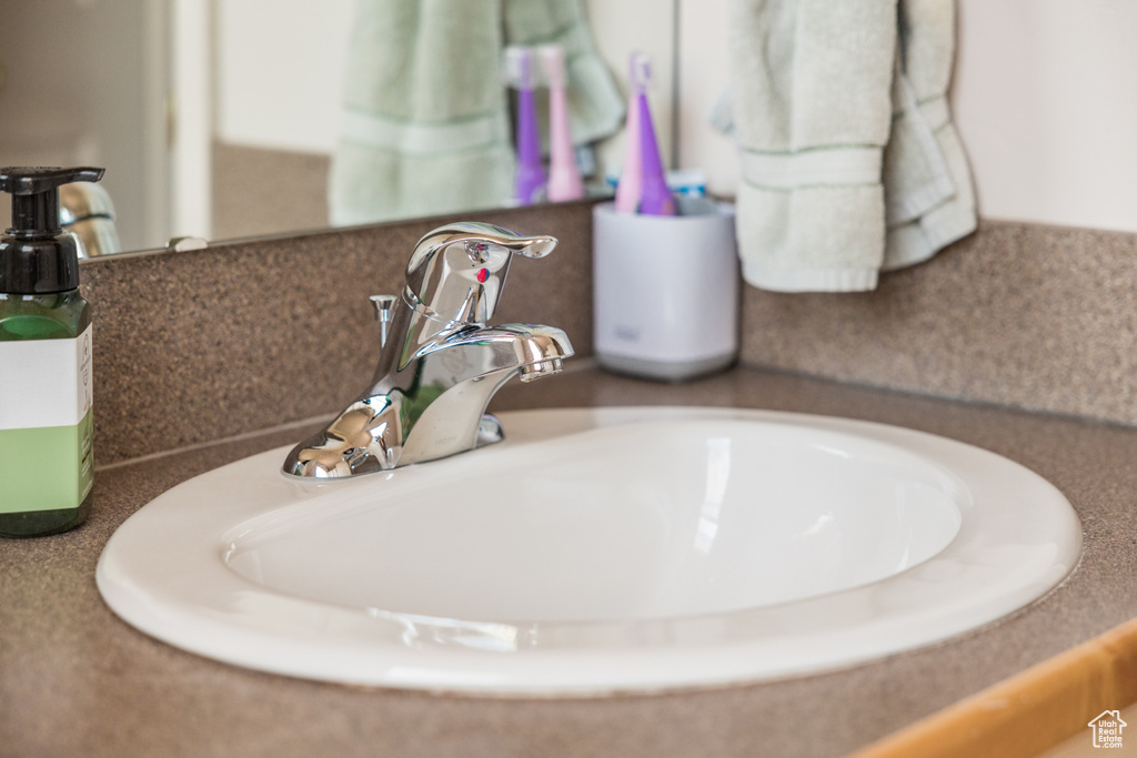 Bathroom view of a sink and tasteful backsplash