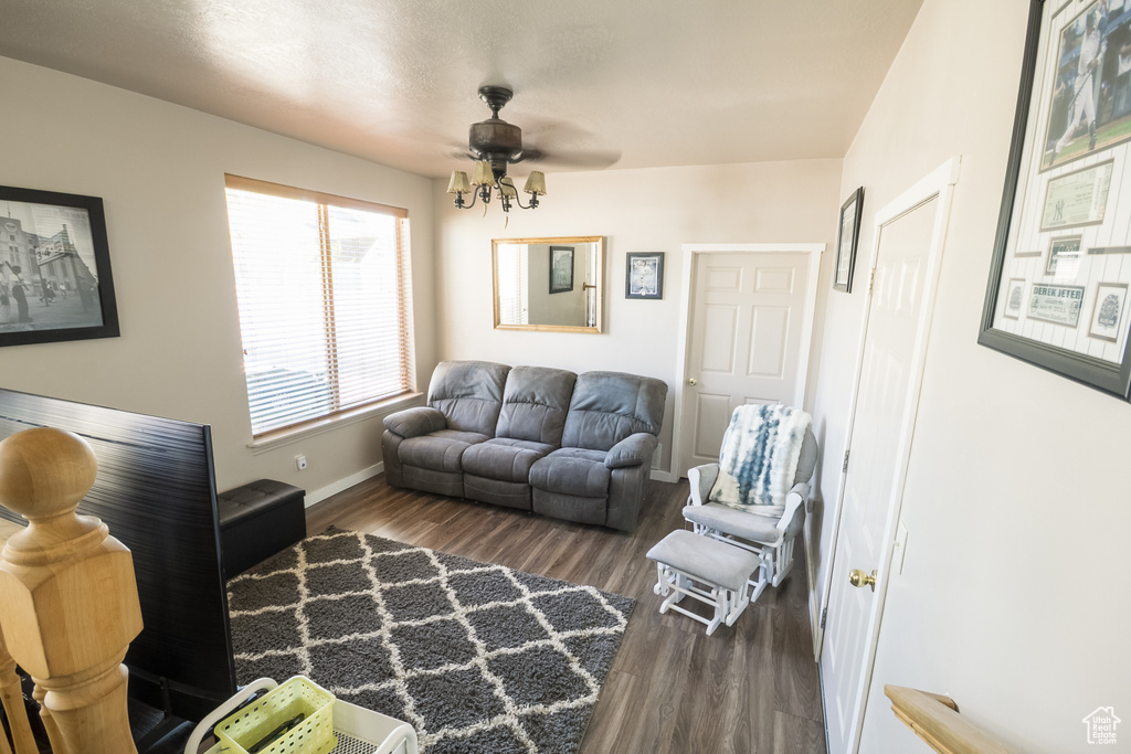 Living area featuring wood finished floors, ceiling fan, and baseboards