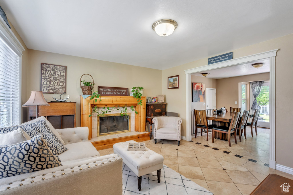 Living area with light tile patterned floors, baseboards, and a premium fireplace