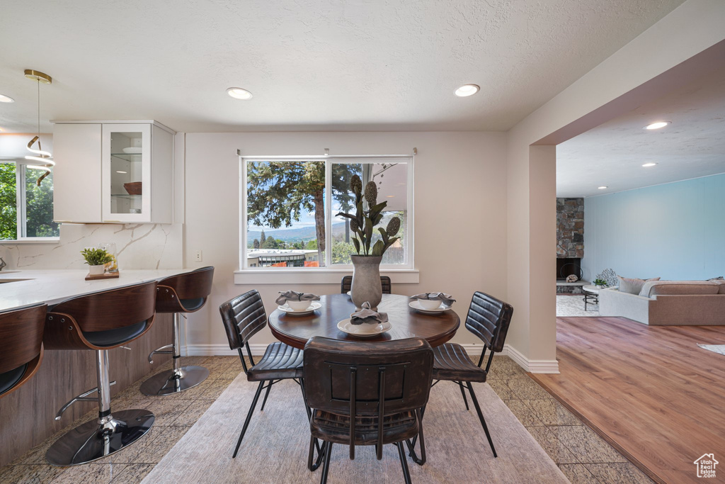 Dining room with recessed lighting, baseboards, and a fireplace