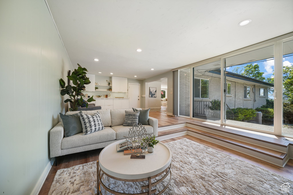 Living room featuring wood finished floors, baseboards, and recessed lighting