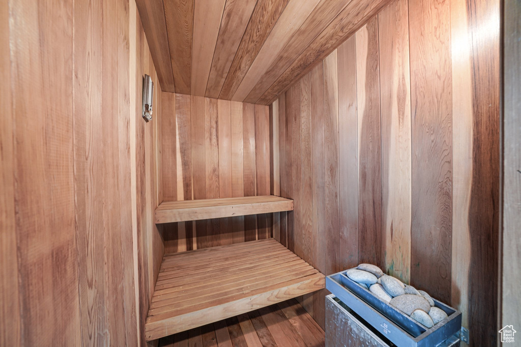 Relaxing sauna / steam room with wood walls and wood finished floors