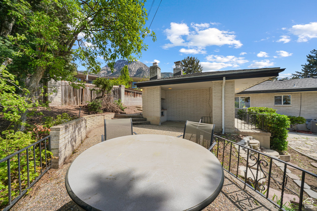 View of patio / terrace with outdoor dining area and a mountain view