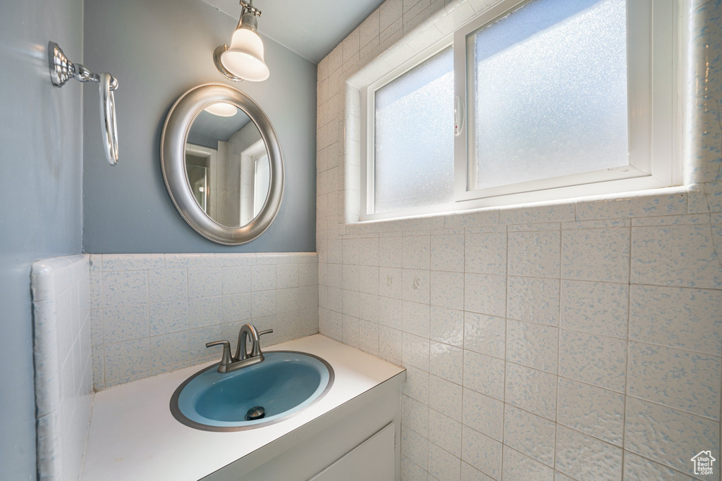 Bathroom with tile walls and vanity