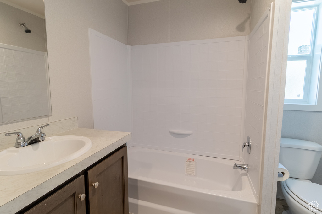 Full bathroom with plenty of natural light, toilet, vanity, and shower / tub combination