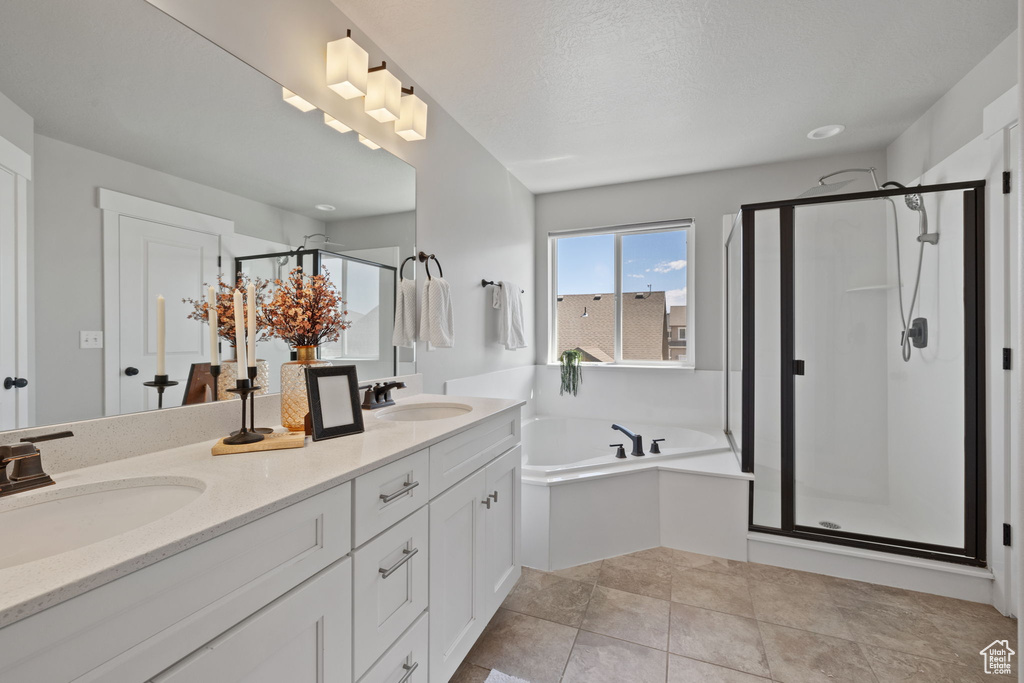 Bathroom with a shower stall, a garden tub, and double vanity