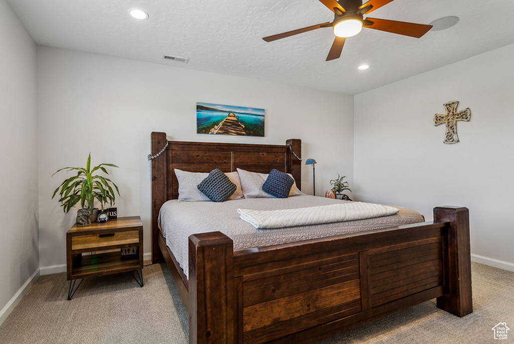 Bedroom with light colored carpet, baseboards, a ceiling fan, and recessed lighting