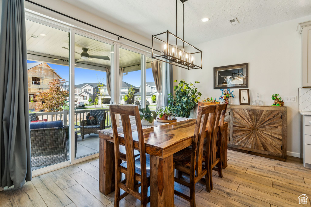Dining area featuring light wood-style flooring and recessed lighting