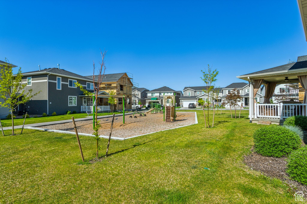 View of community featuring a residential view and a yard